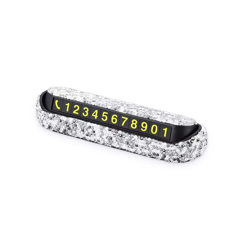 A sparkly, rhinestone-encrusted car dashboard phone number display with yellow numbers and phone icons against a black background, showing the number sequence 12345678901.