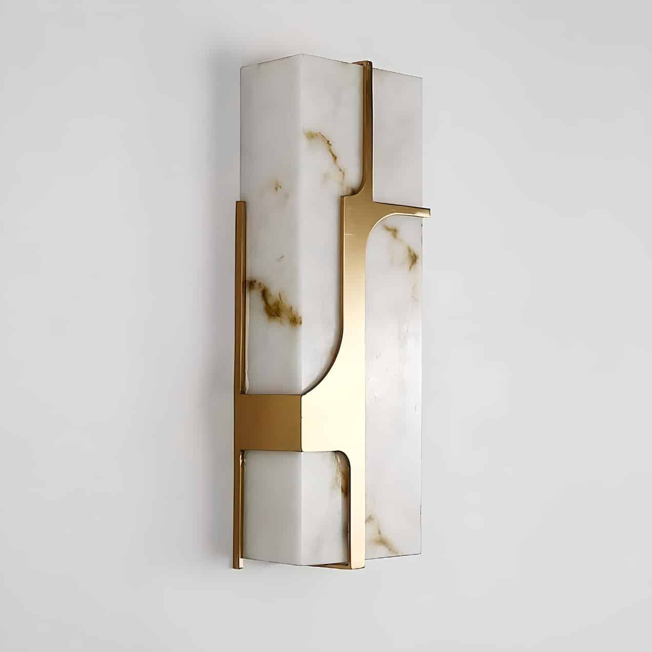 A modern wall sconce with a rectangular design, featuring a white stone-like material with brown marbling and sleek gold metal accents, mounted on a plain white wall.